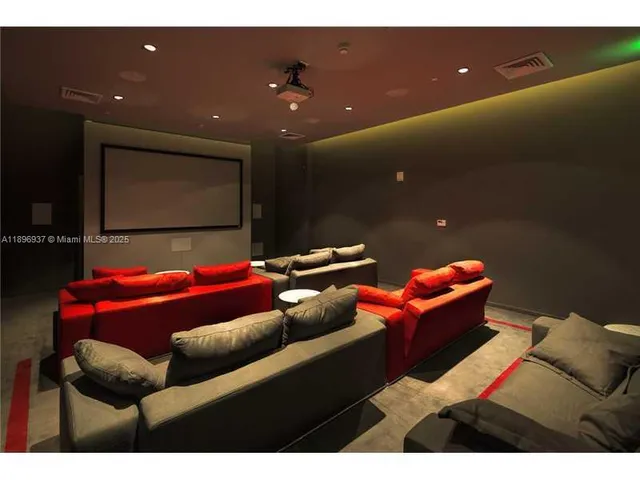 a outdoor living room with furniture and a projector screen