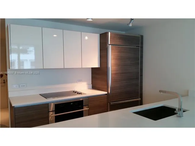 a kitchen with a refrigerator and cabinets