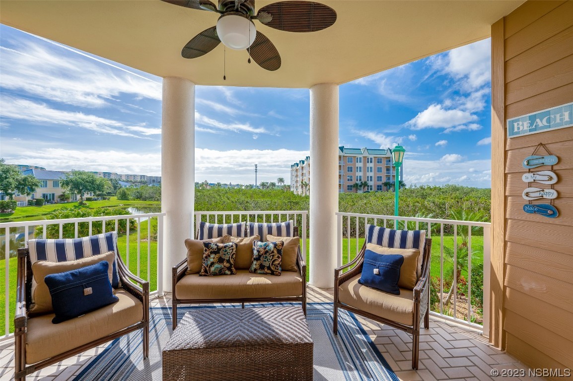 4620 Riverwalk Village Court, Unit 7206 Ponce Inlet, FL 32127 - Photo 17 of 48 a balcony with wooden floor and outdoor seating