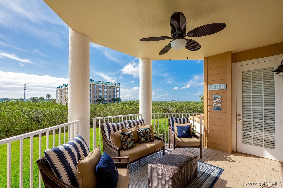 4620 Riverwalk Village Court, Unit 7206 Ponce Inlet, FL 32127 - Photo 19 of 48 a balcony view with a seating space and a floor to ceiling window