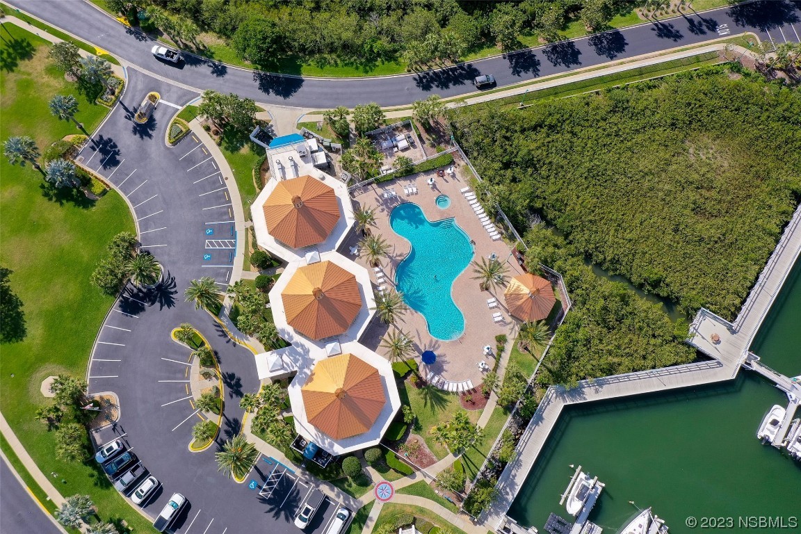 4620 Riverwalk Village Court, Unit 7206 Ponce Inlet, FL 32127 - Photo 25 of 48 an aerial view of a house with swimming pool and a yard