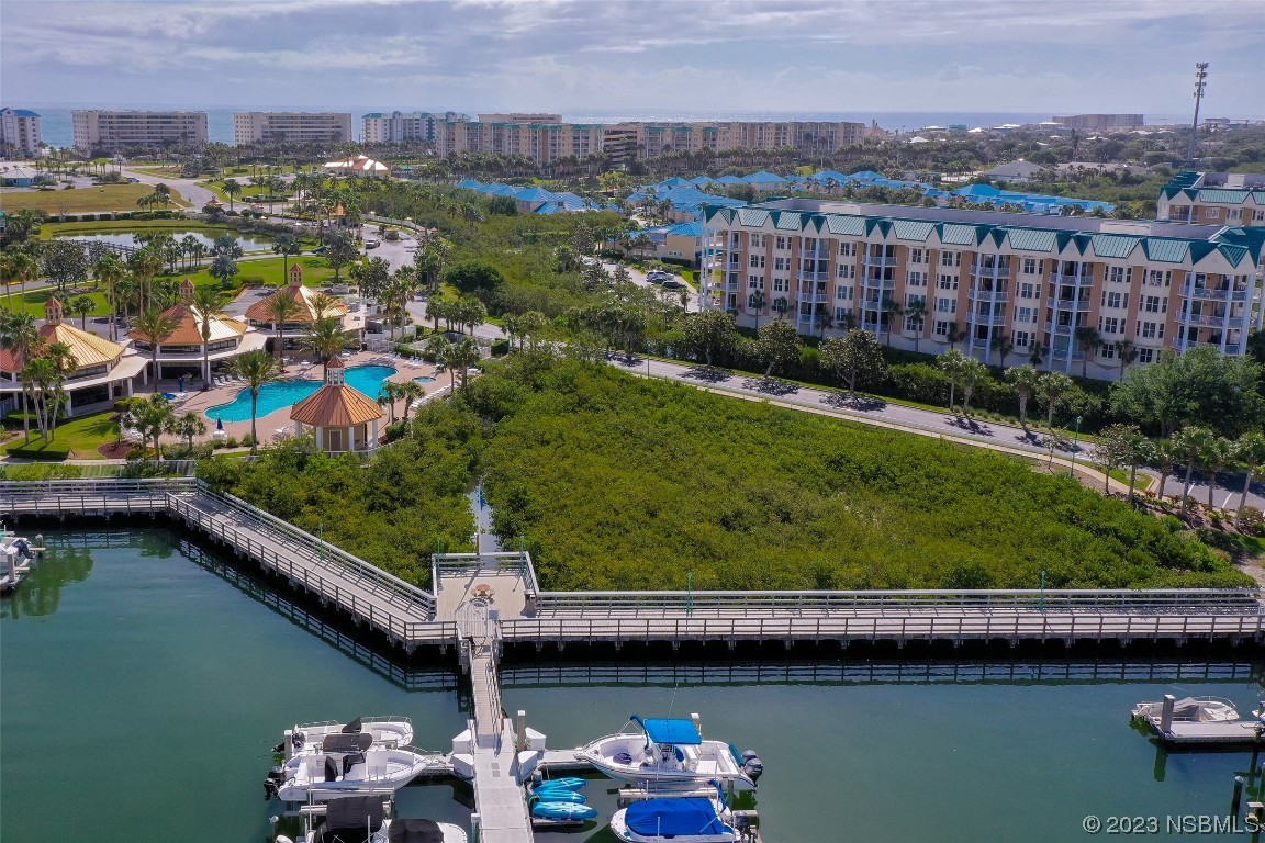 4620 Riverwalk Village Court, Unit 7206 Ponce Inlet, FL 32127 - Photo 33 of 48 a view of a lake with a house