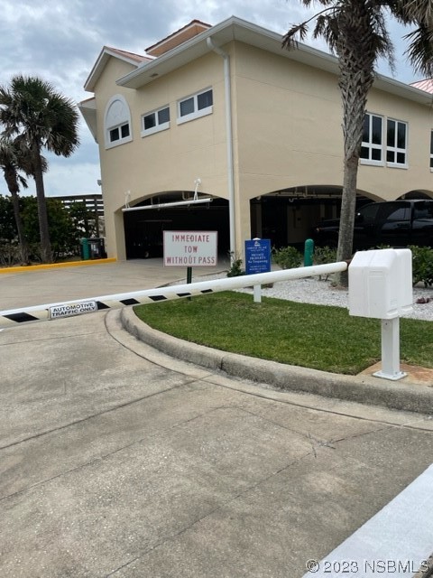 4620 Riverwalk Village Court, Unit 7206 Ponce Inlet, FL 32127 - Photo 39 of 48 a front view of a house with a yard and a garage