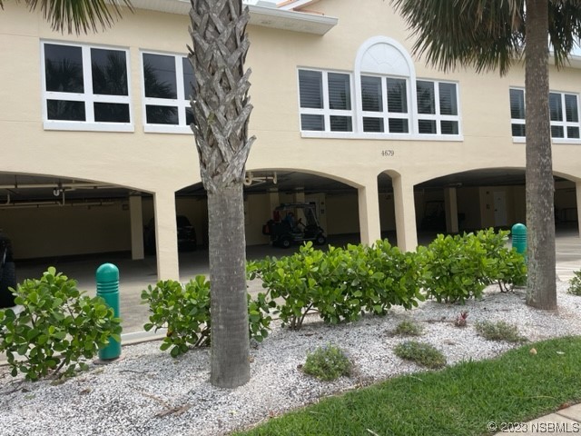 4620 Riverwalk Village Court, Unit 7206 Ponce Inlet, FL 32127 - Photo 40 of 48 a front view of a house with a garden