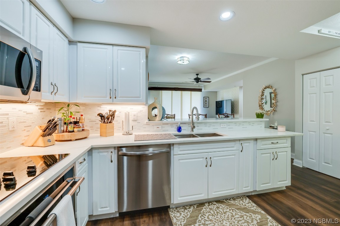 4620 Riverwalk Village Court, Unit 7206 Ponce Inlet, FL 32127 - Photo 4 of 48 a kitchen with stainless steel appliances granite countertop a sink stove and cabinets