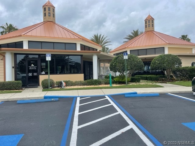 4620 Riverwalk Village Court, Unit 7206 Ponce Inlet, FL 32127 - Photo 43 of 48 a view of a house with a swimming pool and a yard with plants