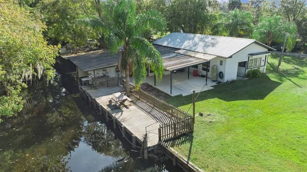 a view of house with yard and outdoor seating