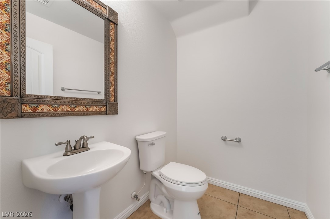 3175 Via Seranova Henderson, NV 89044 - Photo 17 of 45 This clean and functional bathroom features a modern pedestal sink and essential fixtures.