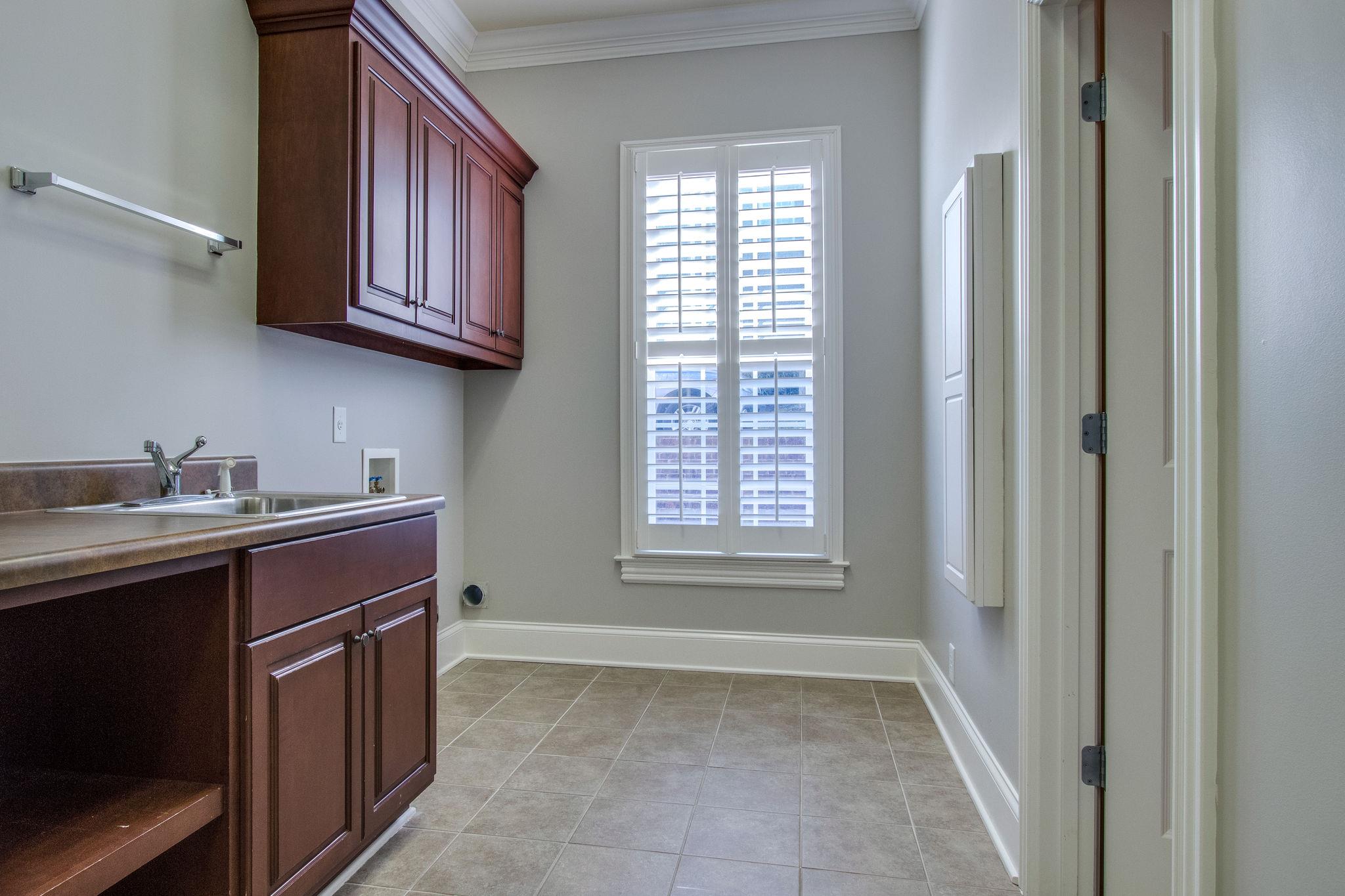 413 Sandcastle Road Franklin, TN 37069 - Photo 15 of 29 The laundry room can be assessed through the master closet in addition to the hall.