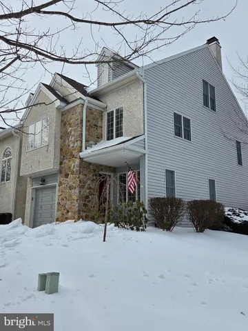 a view of a house with a snow in the yard