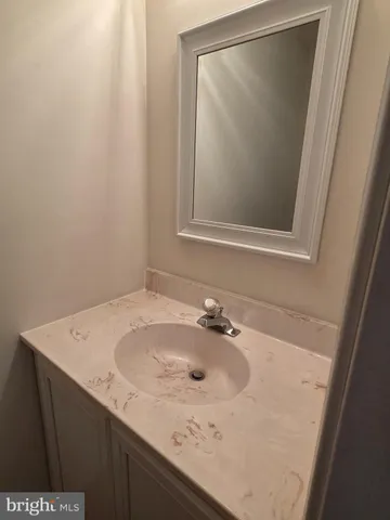 a bathroom with a sink and mirror