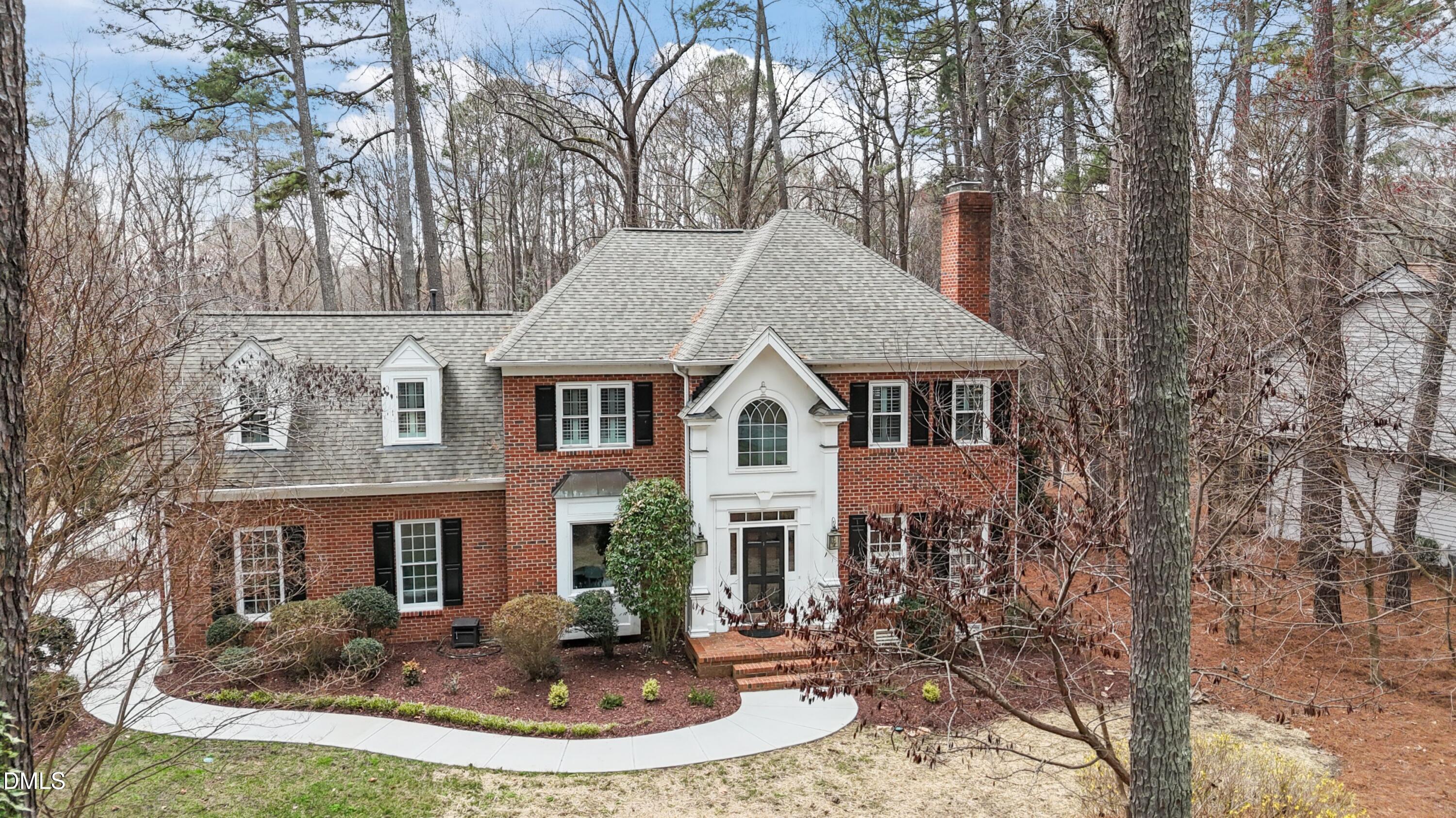 10728 Winding Wood Trail Raleigh, NC 27613 - Photo 1 of 54 a front view of a house with a yard