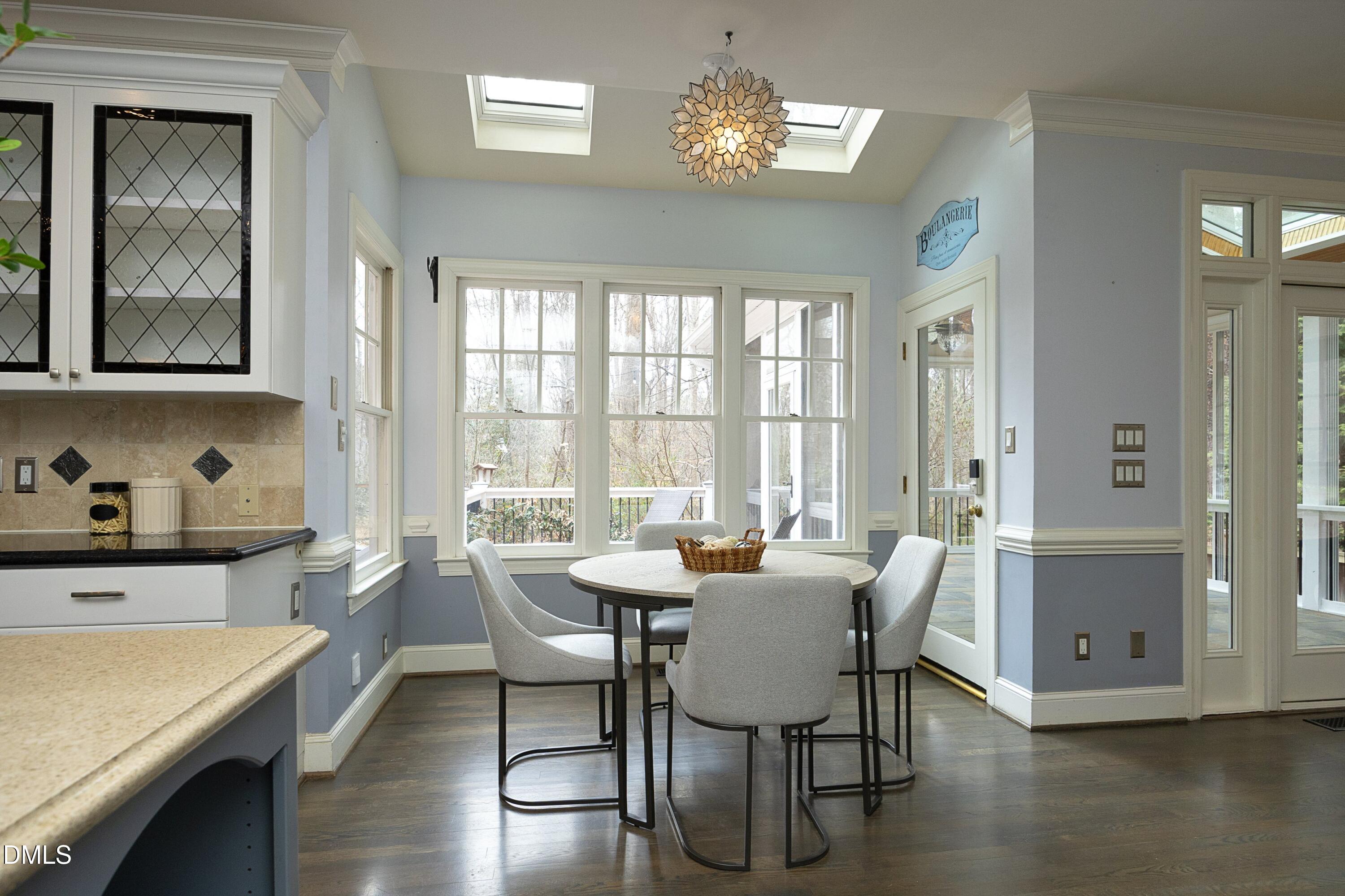 10728 Winding Wood Trail Raleigh, NC 27613 - Photo 11 of 54 a view of a dining room with furniture window and wooden floor