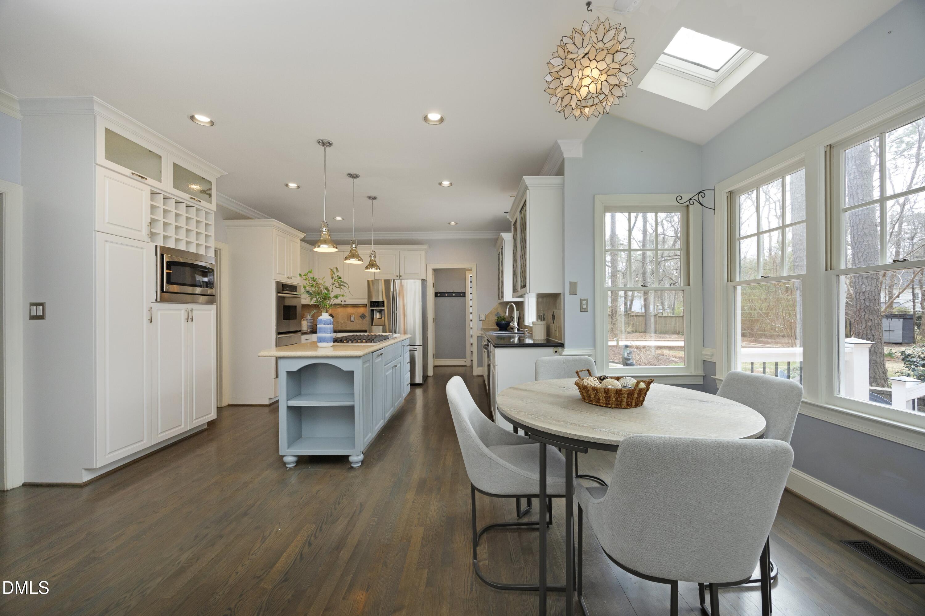 10728 Winding Wood Trail Raleigh, NC 27613 - Photo 12 of 54 a view of a dining room with furniture window and wooden floor