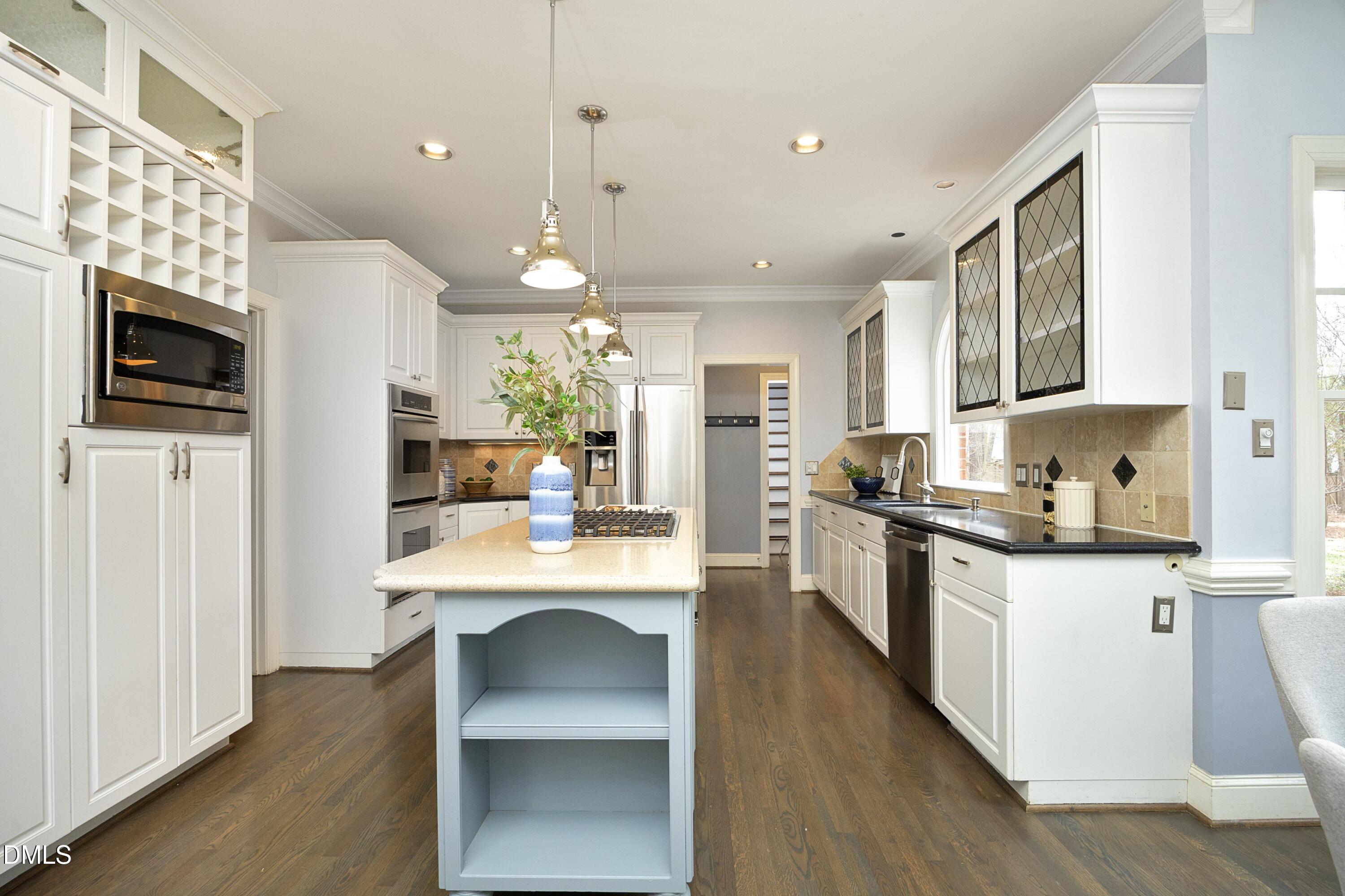 10728 Winding Wood Trail Raleigh, NC 27613 - Photo 13 of 54 a kitchen with a sink microwave and refrigerator