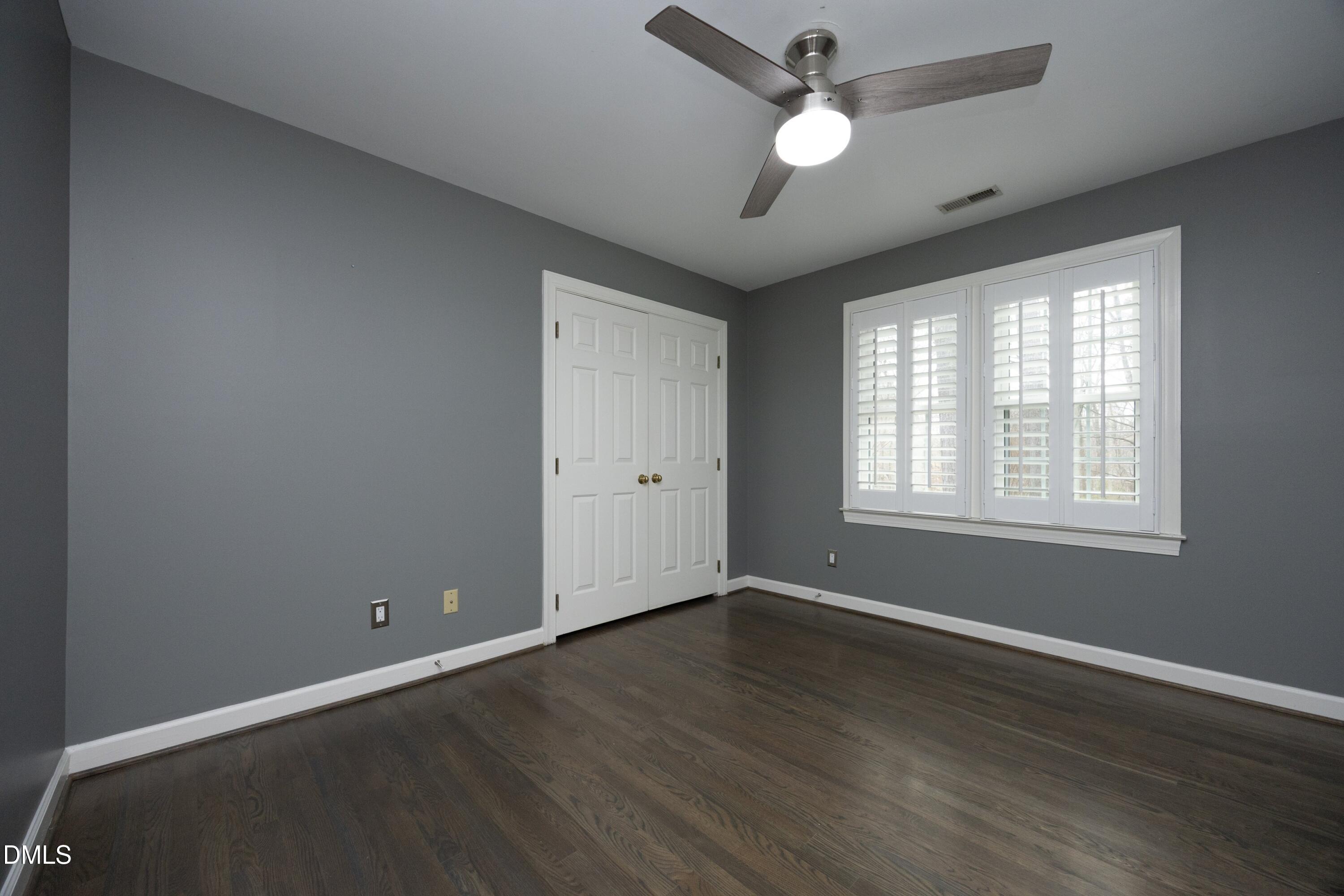 10728 Winding Wood Trail Raleigh, NC 27613 - Photo 25 of 54 a view of an empty room with wooden floor and a window