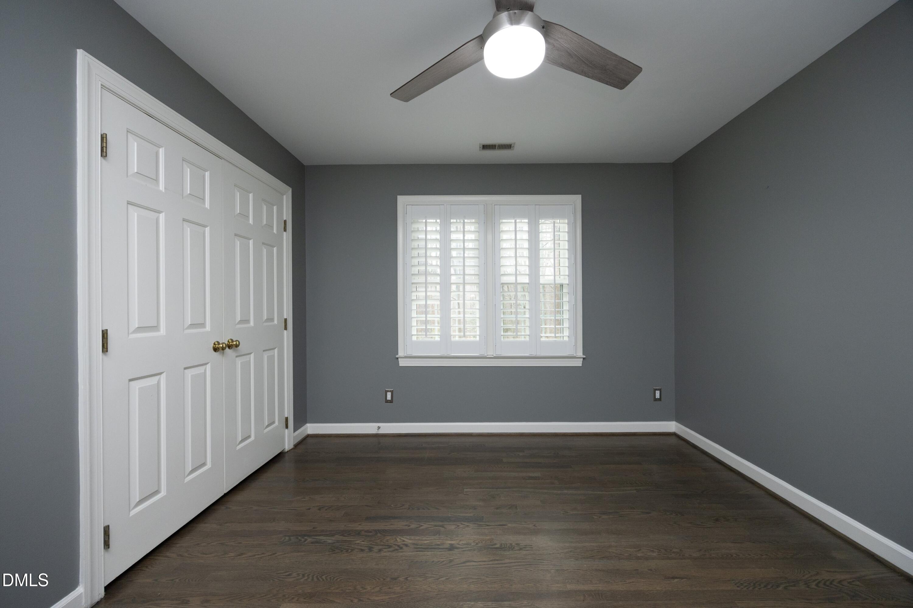 10728 Winding Wood Trail Raleigh, NC 27613 - Photo 26 of 54 an empty room with wooden floor and windows