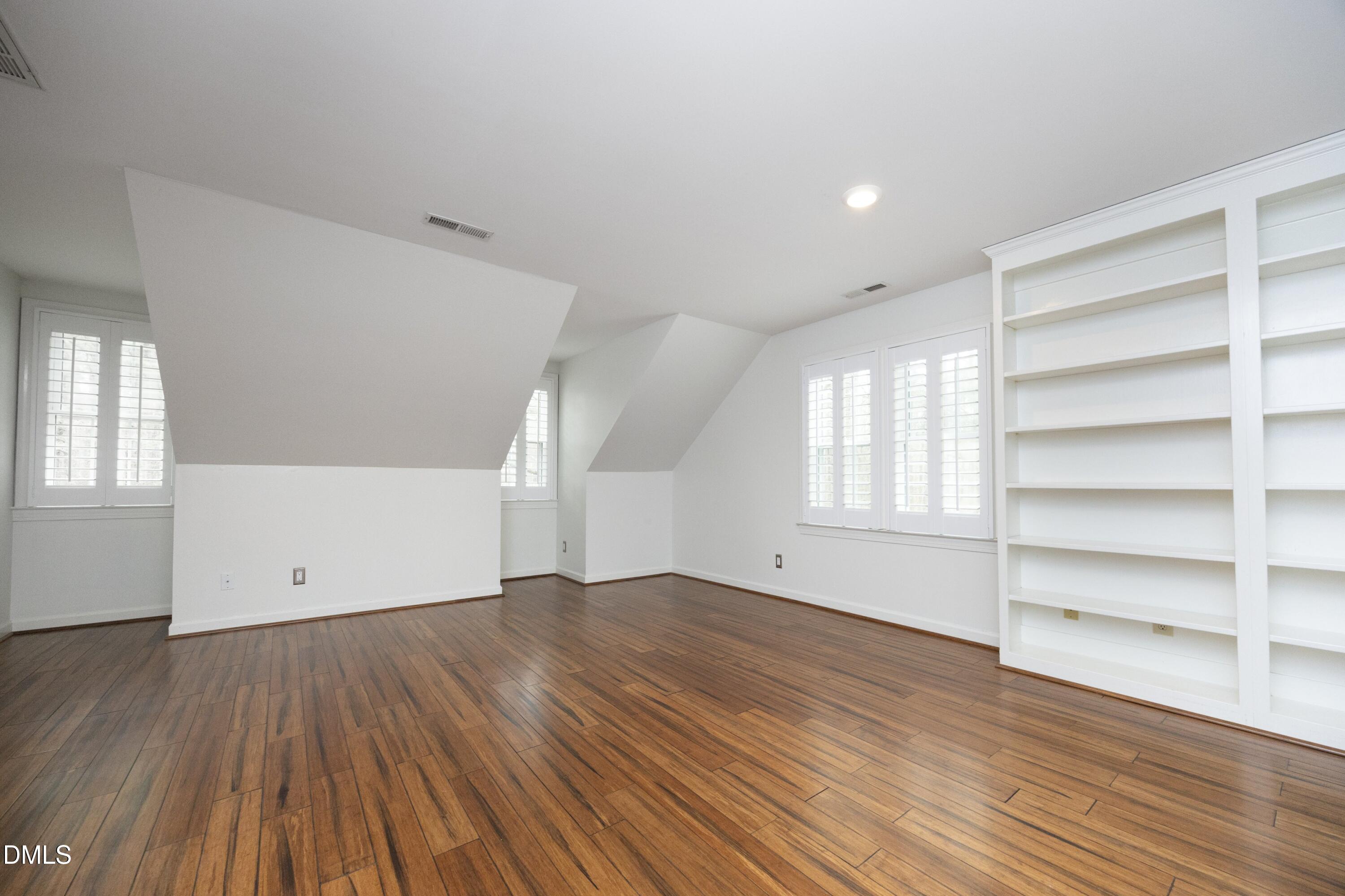 10728 Winding Wood Trail Raleigh, NC 27613 - Photo 29 of 54 wooden floor in an empty room with a window