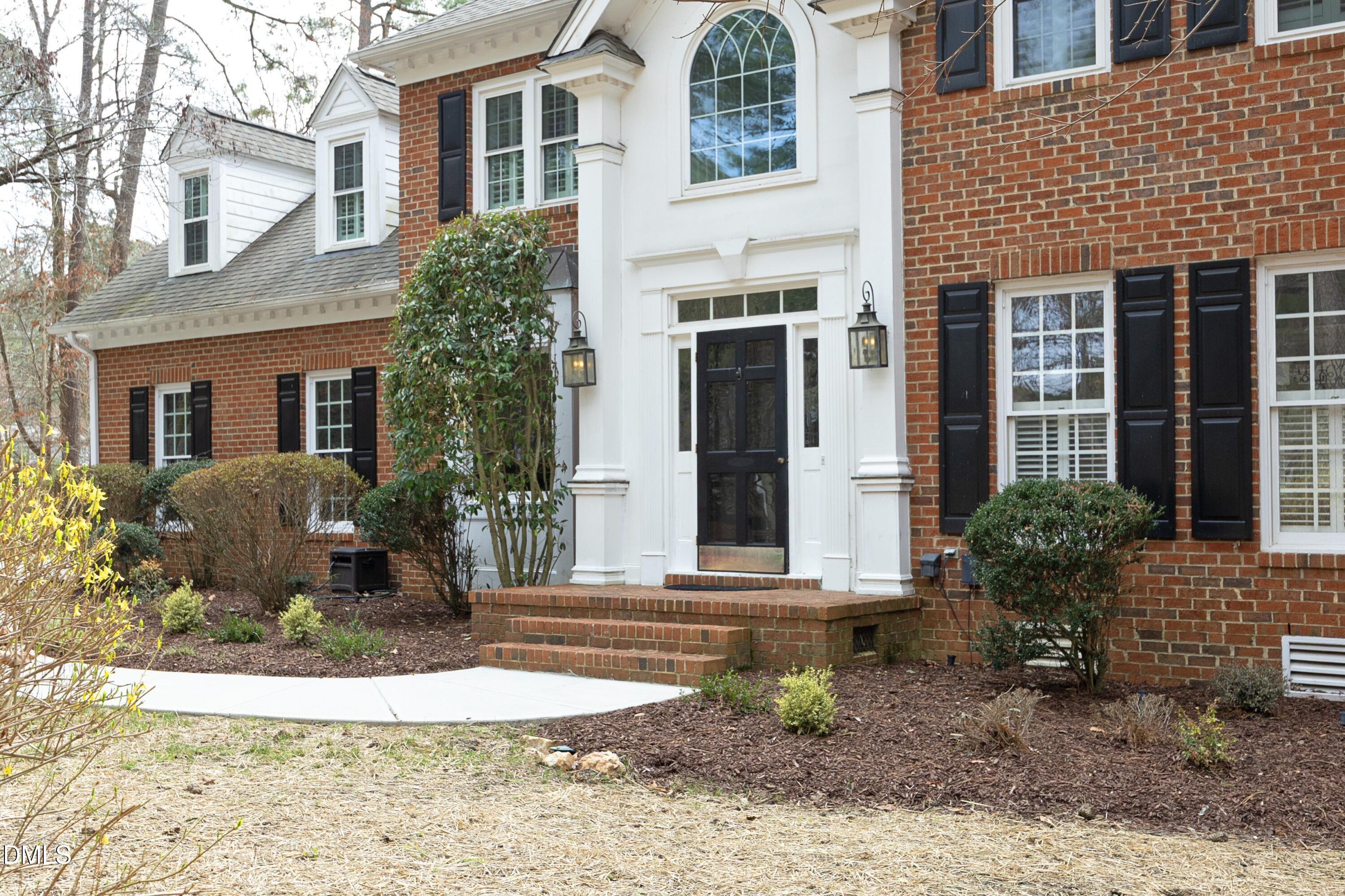 10728 Winding Wood Trail Raleigh, NC 27613 - Photo 2 of 54 a front view of a house with garden