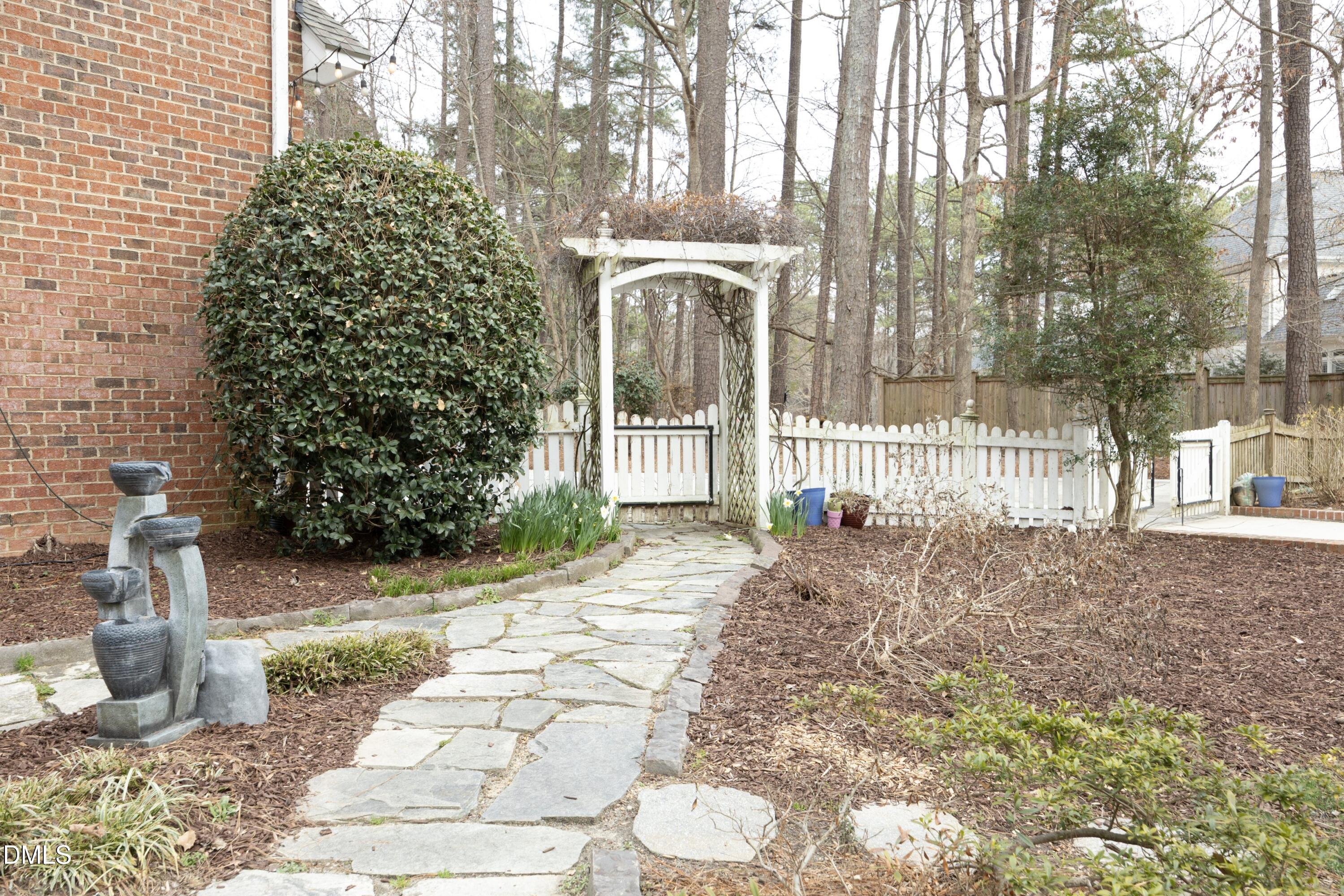 10728 Winding Wood Trail Raleigh, NC 27613 - Photo 38 of 54 a view of a house with a yard and pathway