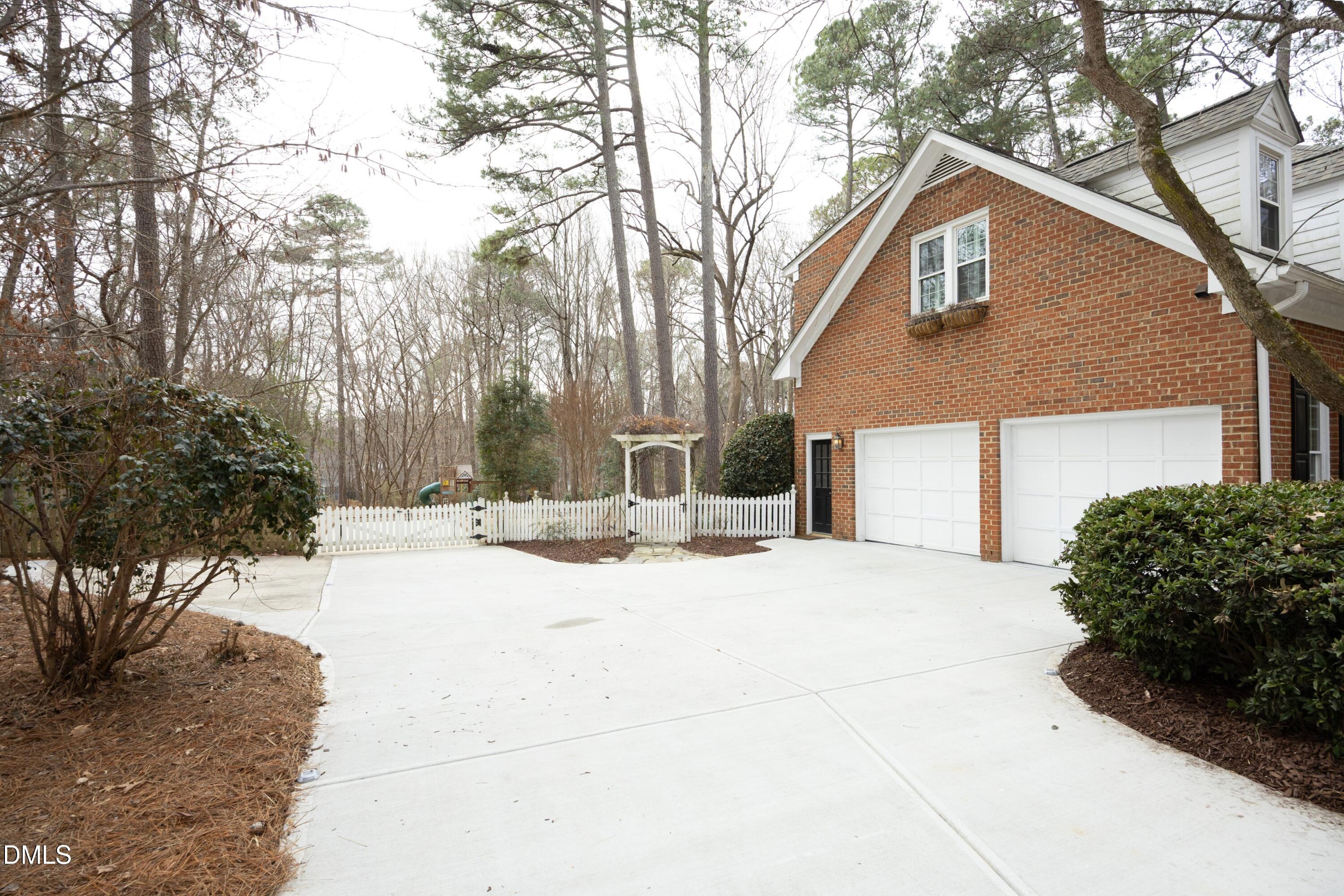 10728 Winding Wood Trail Raleigh, NC 27613 - Photo 44 of 54 a view of a house with snow on the road
