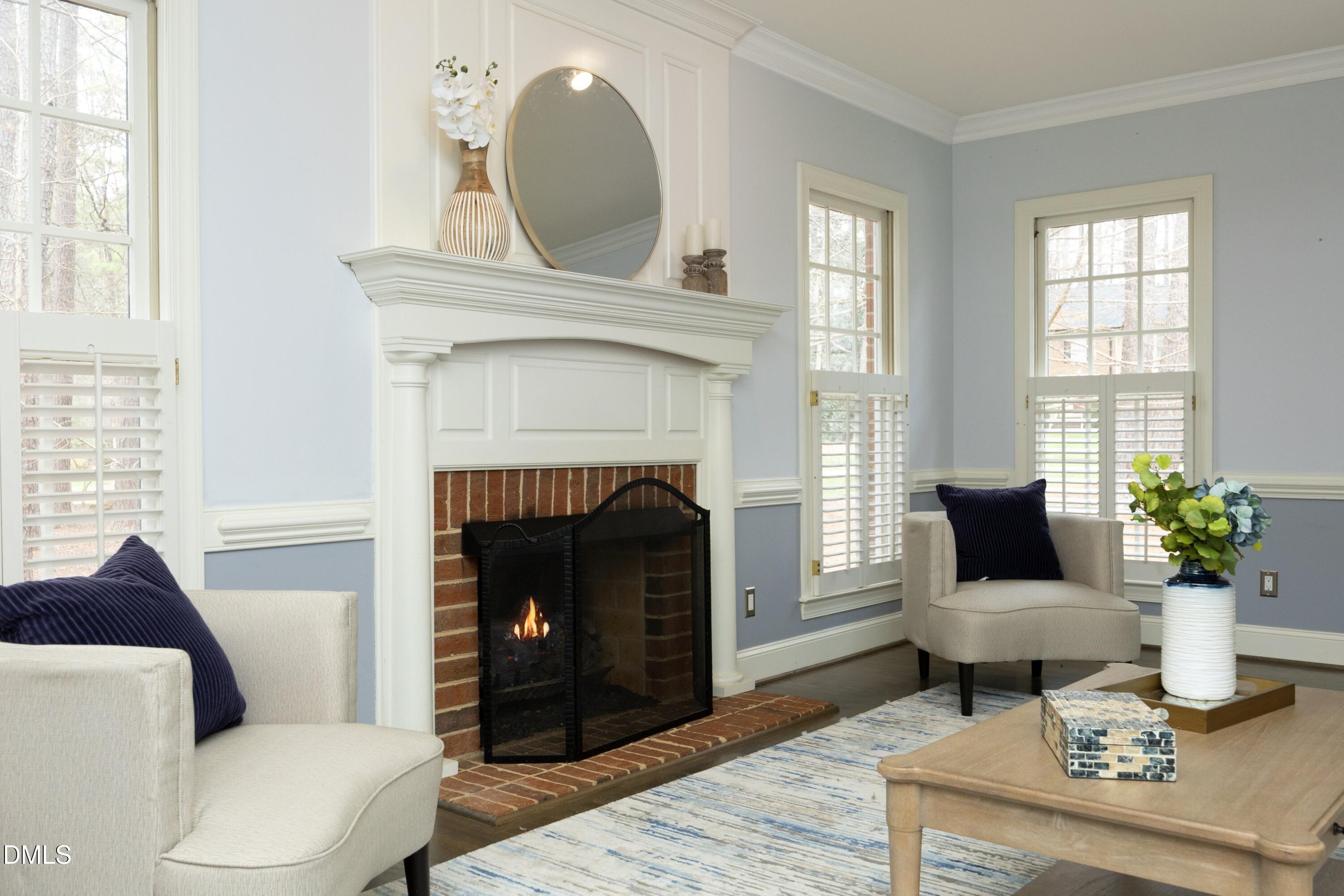 10728 Winding Wood Trail Raleigh, NC 27613 - Photo 7 of 54 a living room with furniture a fireplace and a potted plant