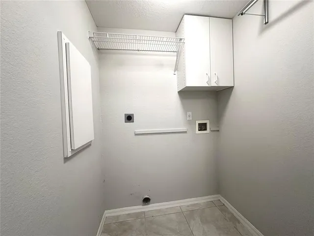 a view of storage and utility room with a window