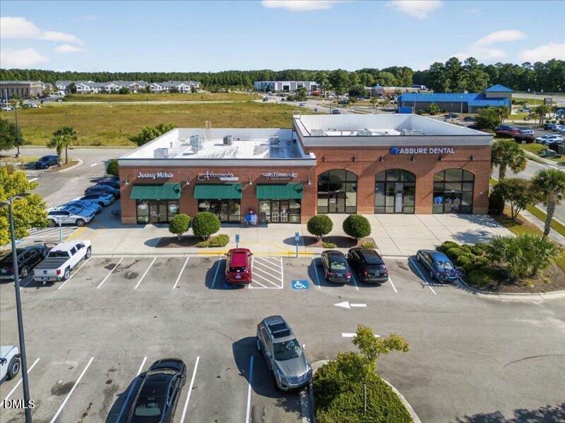 110 Hewett-Burton Road Southeast Leland, NC 28451 - Photo 18 of 27 a view of multiple houses with outdoor seating