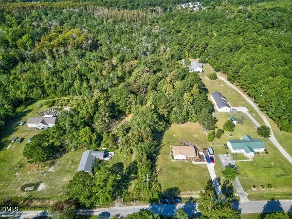 an aerial view of a residential houses with outdoor space and street view