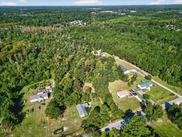 an aerial view of a residential houses with city view