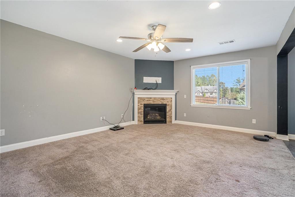 115 Floating Leaf Way Dallas, GA 30132 - Photo 9 of 47 a view of an empty room with chandelier fan and fire place