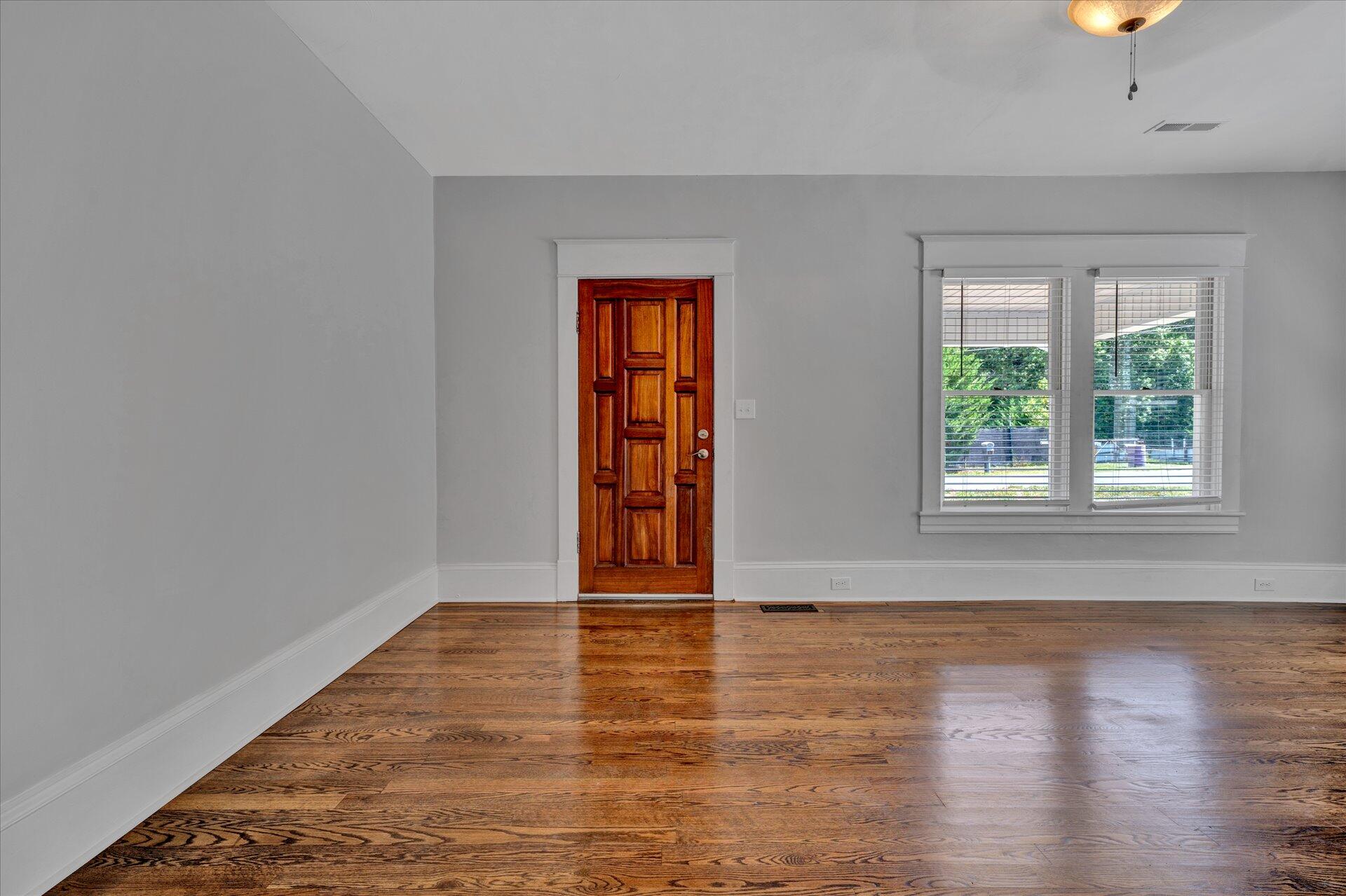 1853 Navigation Point Goodview, VA 24095 - Photo 3 of 38 a view of an empty room with wooden floor and window