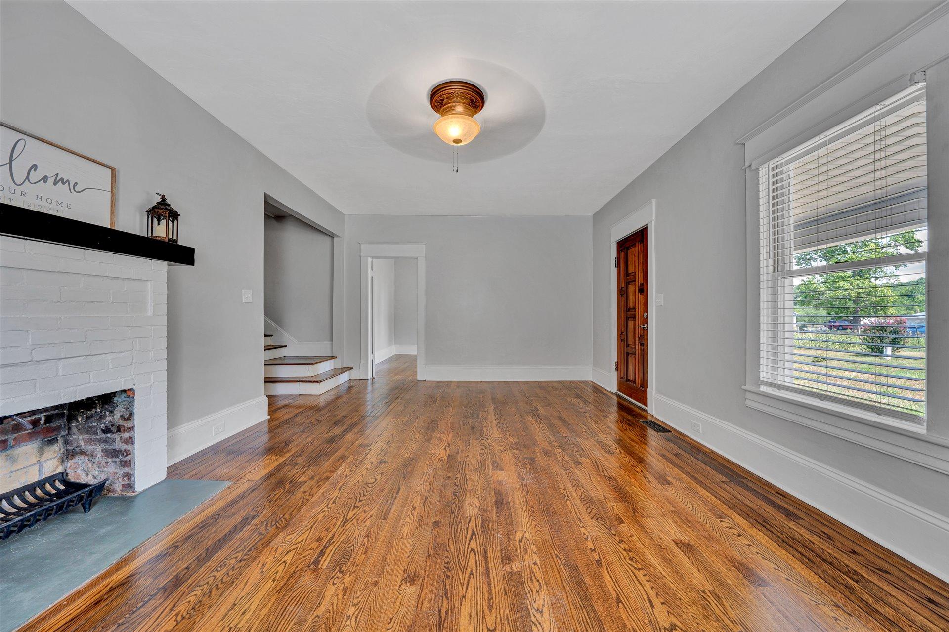 1853 Navigation Point Goodview, VA 24095 - Photo 4 of 38 a view of empty room with wooden floor and fireplace