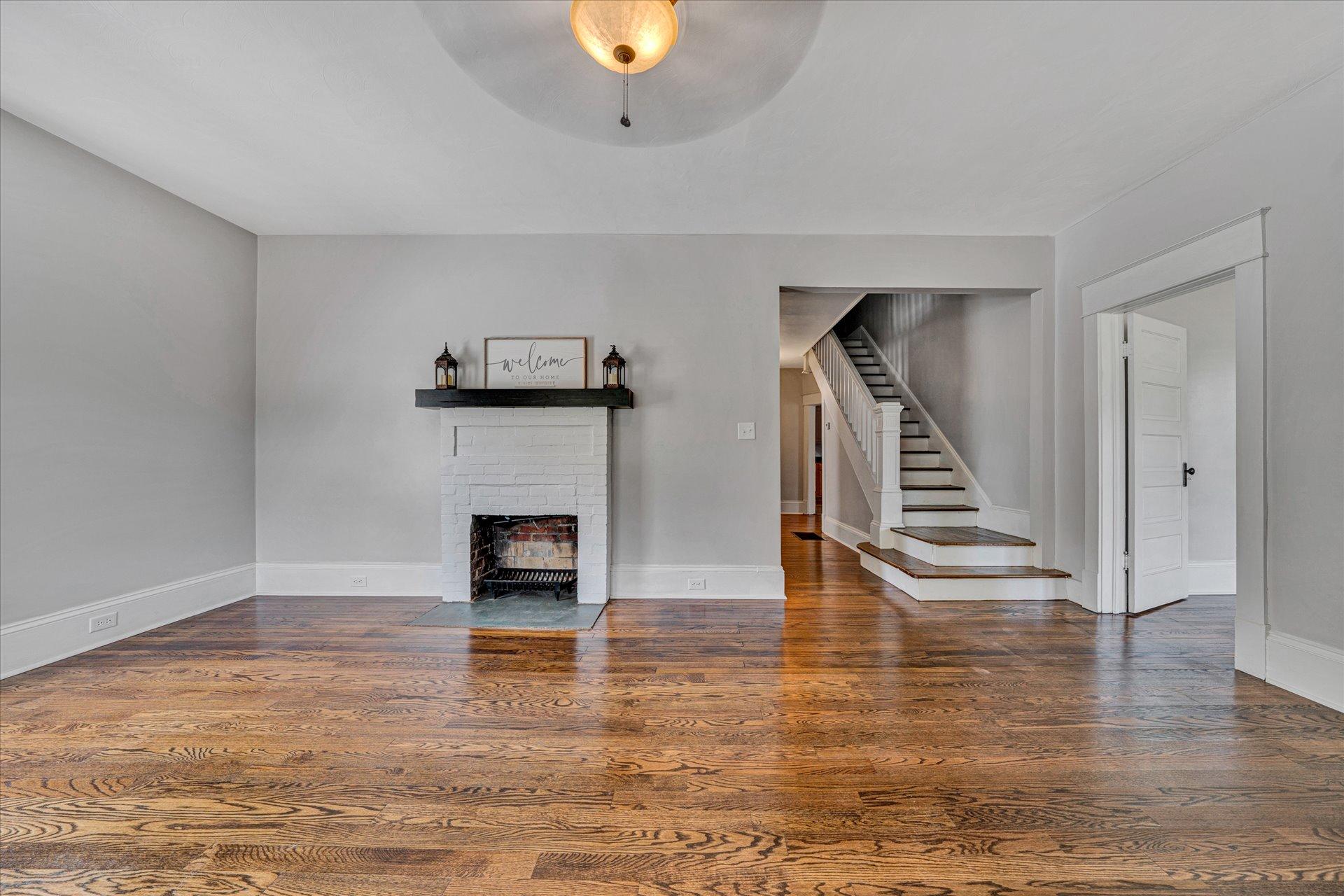 1853 Navigation Point Goodview, VA 24095 - Photo 5 of 38 a view of a livingroom with wooden floor and a fireplace