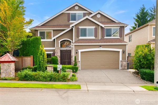 a front view of a house with a yard and garage