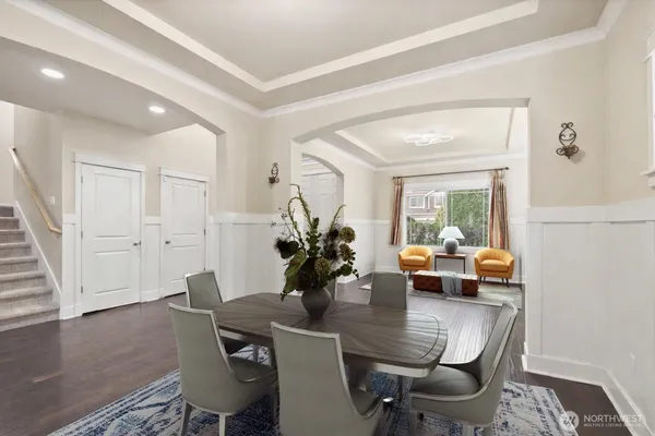 a view of a kitchen with kitchen island granite countertop lots of counter top space and stainless steel appliances