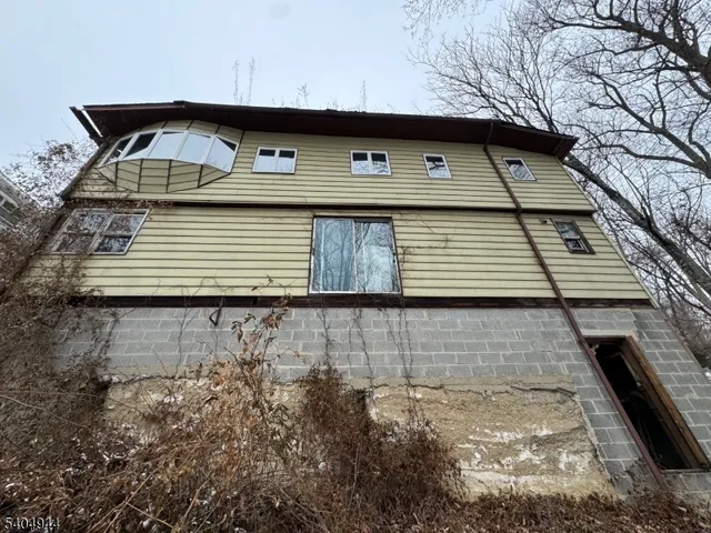 a front view of a house with parking area