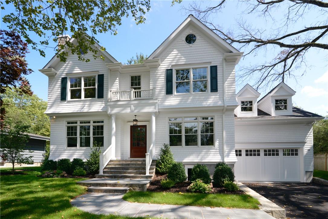 a front view of a house with garden and porch