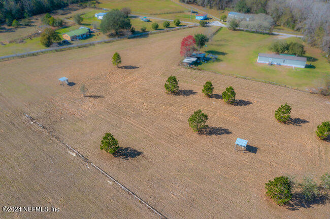 an aerial view of lake and houses with outdoor space