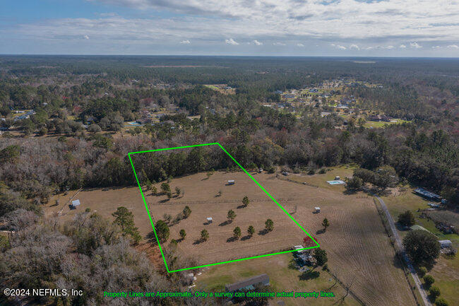 1895 Bennett Road St. Augustine, FL 32092 - Photo 15 of 17 an aerial view of a house with a yard and mountain view in back