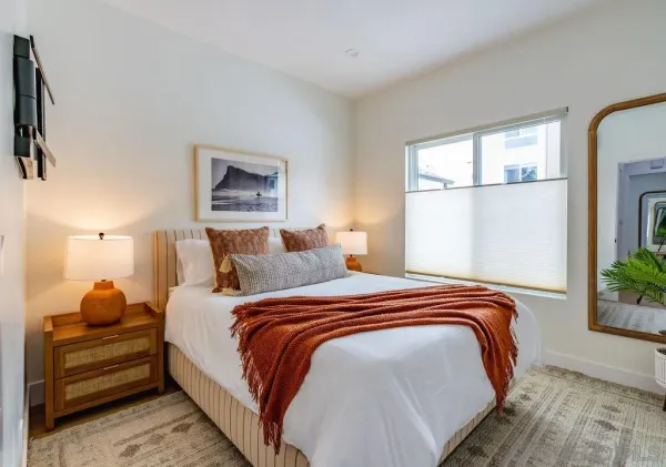 a bedroom with bed and a window