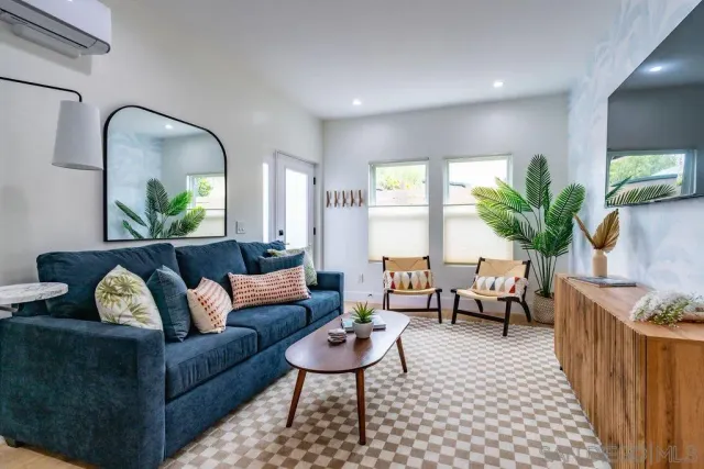 a living room with furniture potted plant and window