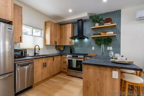 a kitchen with stainless steel appliances granite countertop a sink and a stove