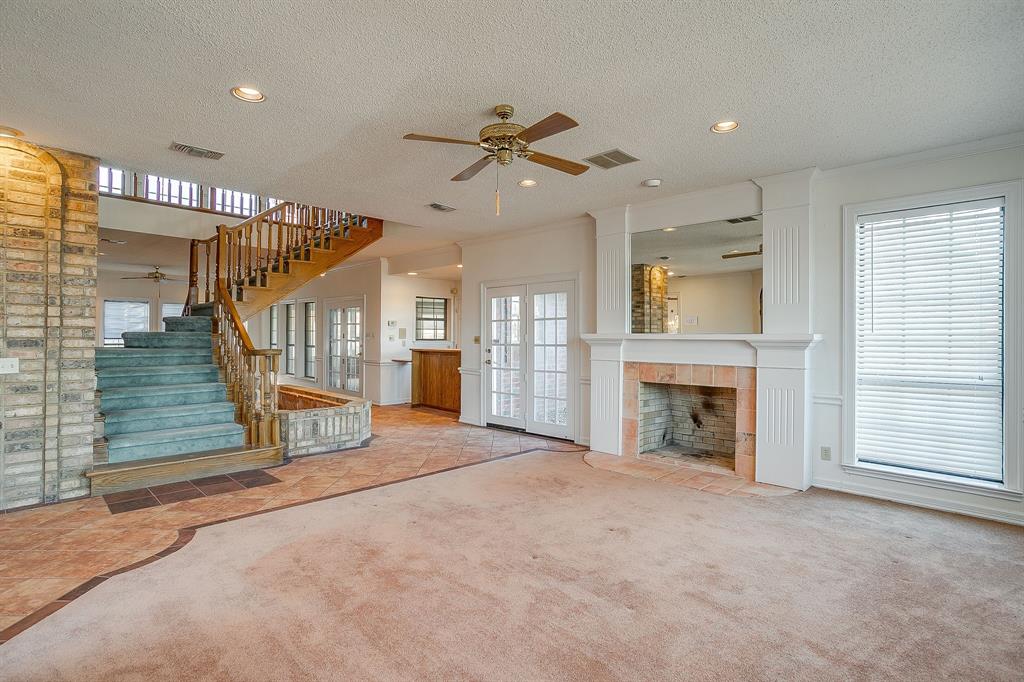 3017 Freeman Lane Crowley, TX 76036 - Photo 12 of 39 a view of an empty room with fireplace and wooden floor