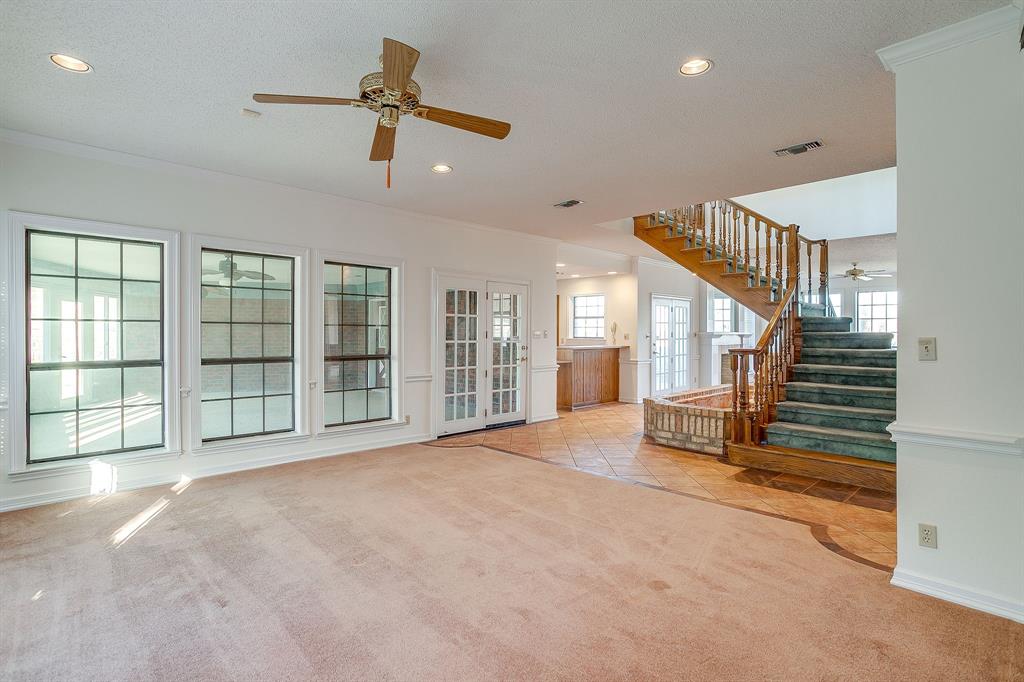 3017 Freeman Lane Crowley, TX 76036 - Photo 14 of 39 a view of an empty room with stairs and a ceiling fan