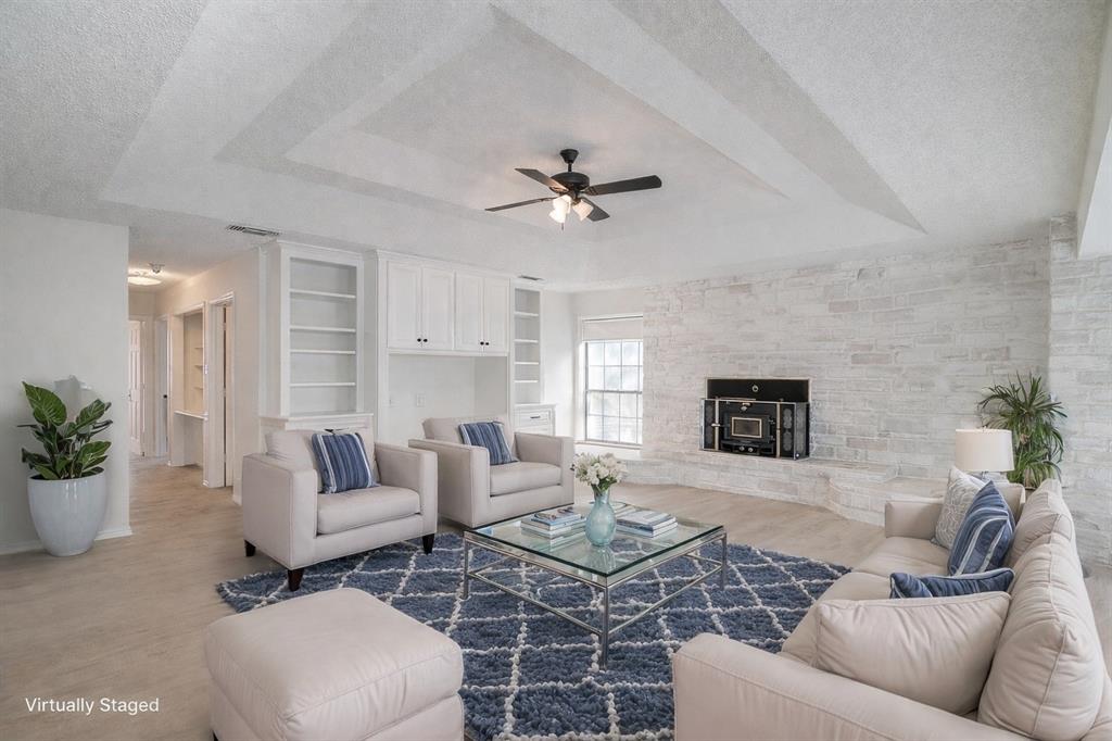 3017 Freeman Lane Crowley, TX 76036 - Photo 17 of 39 a living room with furniture a fireplace and a potted plant