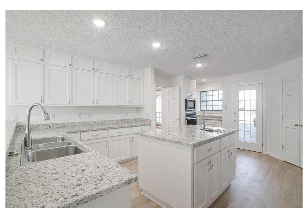 3017 Freeman Lane Crowley, TX 76036 - Photo 19 of 39 a kitchen with a sink stove and cabinets
