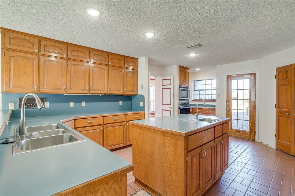 3017 Freeman Lane Crowley, TX 76036 - Photo 20 of 39 a kitchen with stainless steel appliances granite countertop a sink counter space and a window