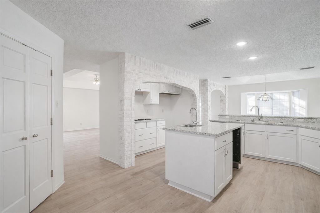 3017 Freeman Lane Crowley, TX 76036 - Photo 21 of 39 a kitchen with granite countertop a sink stove and refrigerator