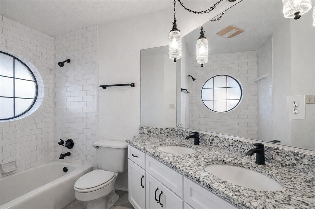 3017 Freeman Lane Crowley, TX 76036 - Photo 33 of 39 a bathroom with a granite countertop sink mirror toilet and bathtub